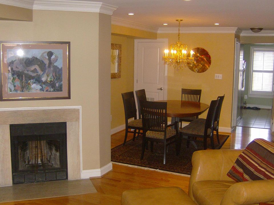 Living room view to the dining room and the kitchen. Also shown is the wood burning fireplace