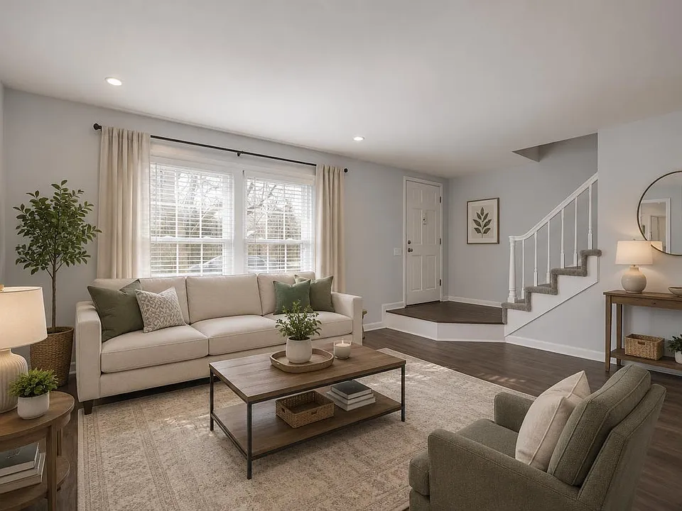 Inviting living room featuring abundant natural light, neutral finishes, and an open flow to the main living areas. Photos are virtually staged.