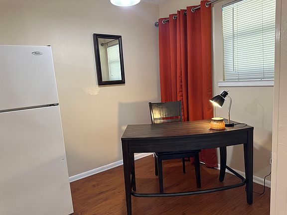 Open-concept layout featuring a seamless flow between the kitchen, living room, and dedicated workstation- perfect for both entertaining and productivity.