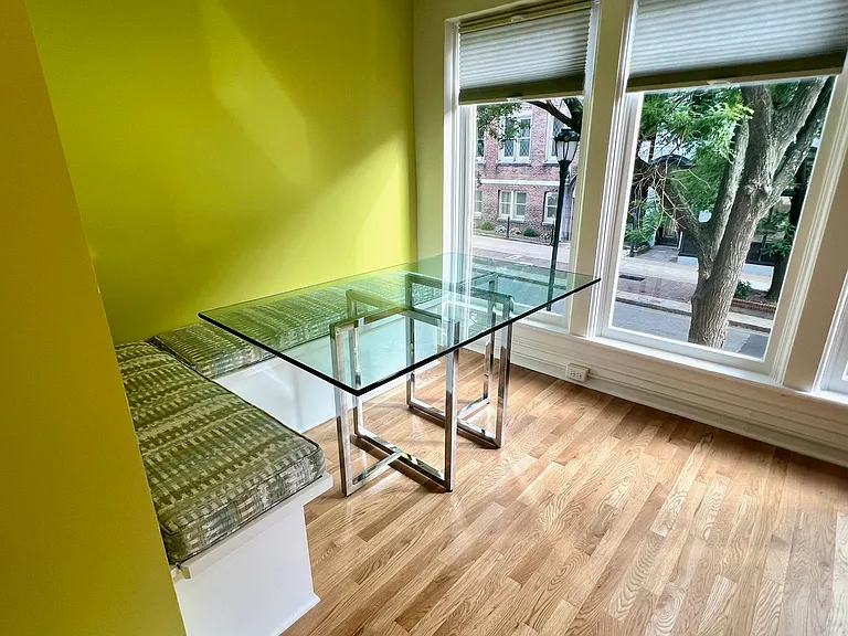 Banquette seating with glass top table (only furnishings in the apartment)