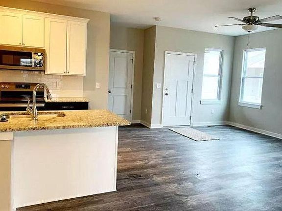 Large open floor plan with wood-look luxury vinyl hardwood floors & 2" faux wood mini blinds throughout! & ceiling fans.