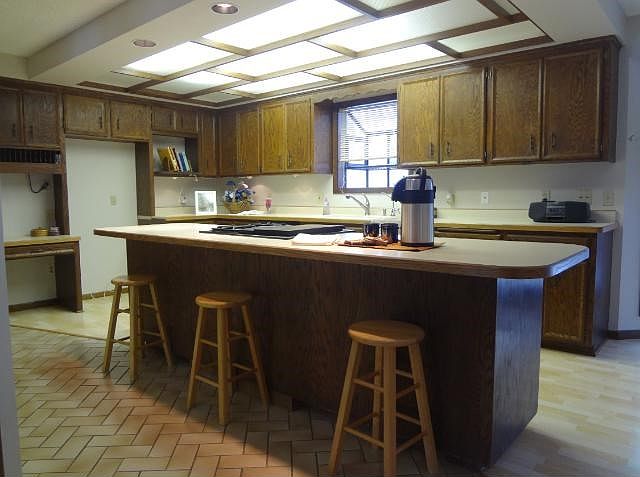 The elongated breakfast bar will have your guests captured for many great conversations!  The owners took delight in mentioning the holidays & breakfast conversations that took place in the "central hub".   Bosch dishwasher, Jenn Air cooktop to boot!