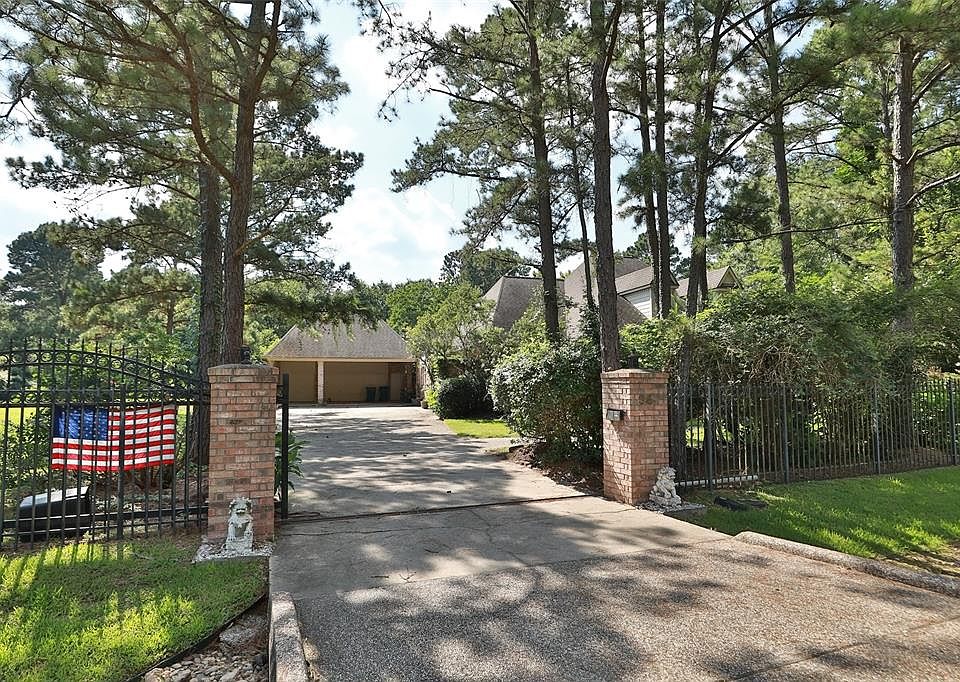 Home has a gated entrance leading to the long driveway. The wrought iron gate is along the entire front of the property.