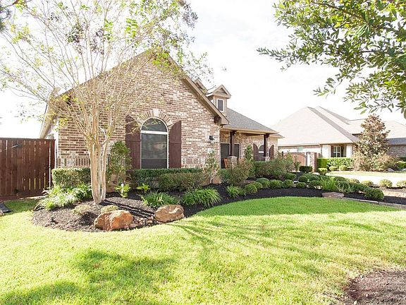 This former model home sits between other former model homes with extensive landscaping & other upgraded features.