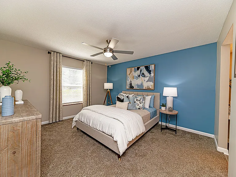Cozy bedroom with carpet and ceiling fan