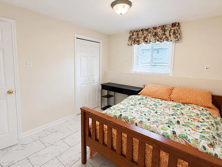 Private bedroom with a double bed, dedicated desk, and closet storage, plus a window for natural light.