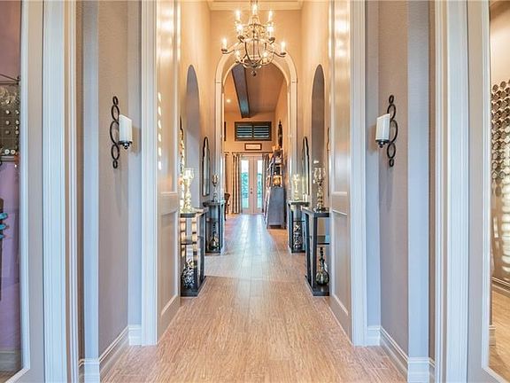 20' Entry Hall with arches, niches, and decor trim , porcelain tile flooring , giving the appearances you would only expect at a