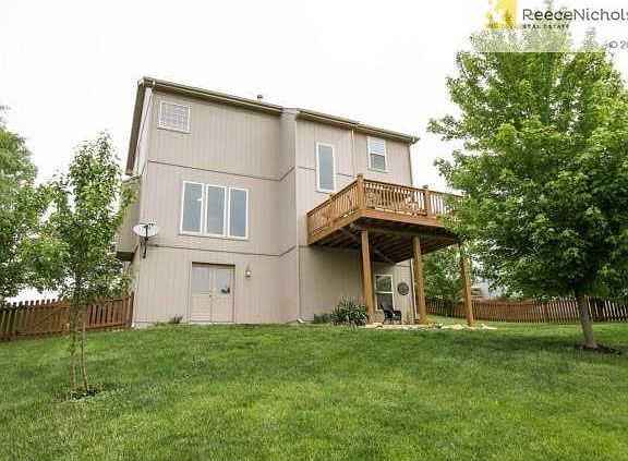 Rear View of Home with double doors into basement!  Covered Pati