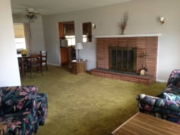Wood burning fireplace warms this open space