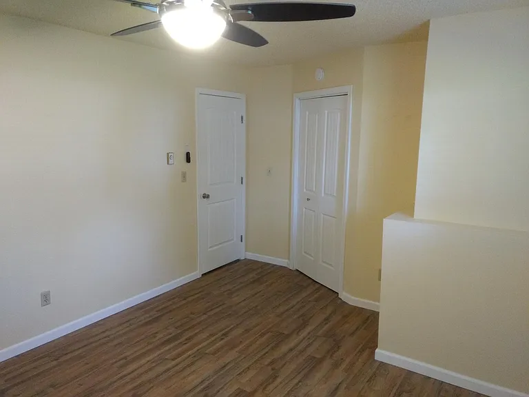 Master bedroom with entry door and door to walk in closet. C