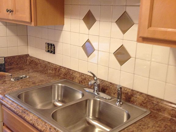 Updated cabinets, backsplash and sink