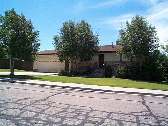 Front of Home with Lush Trees