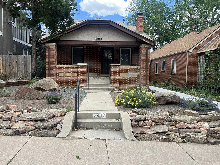 Photo of the main house from the street, basement apartment entrance on the walkway to the right