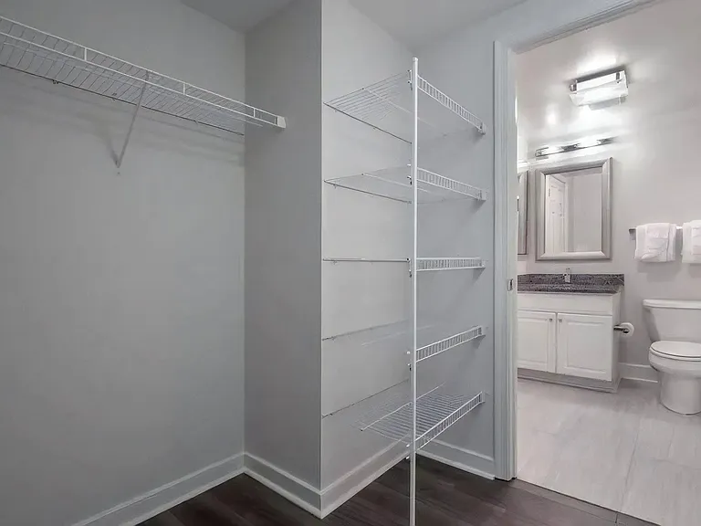 Walk-In Closet With Wire Shelving and Direct Bathroom Access