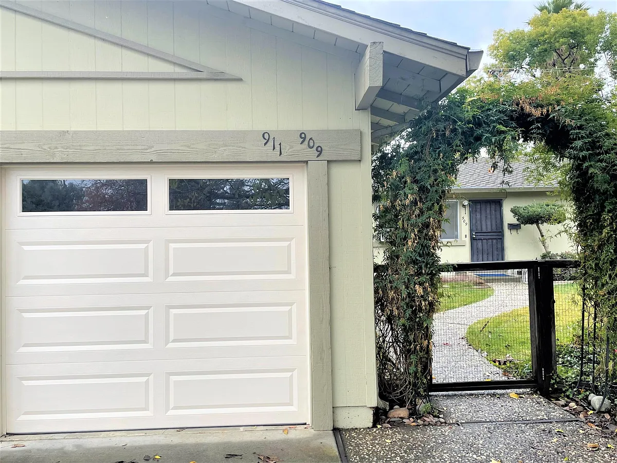 Fenced front yard with attached one car garage - Suntree Ct
