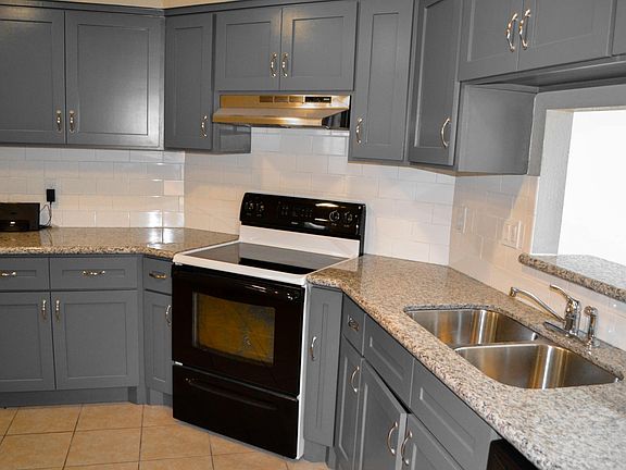 Newly updated kitchen with granite counters and custom cabinets.