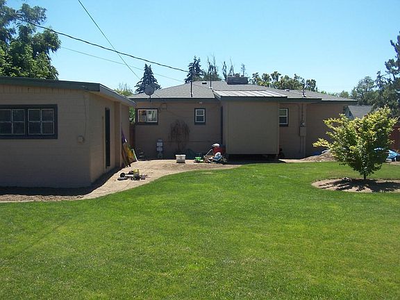 while the front yard has been well maintained, the back yard has potential - it used to look like this. Still fully fenced and plenty of shade for pets.