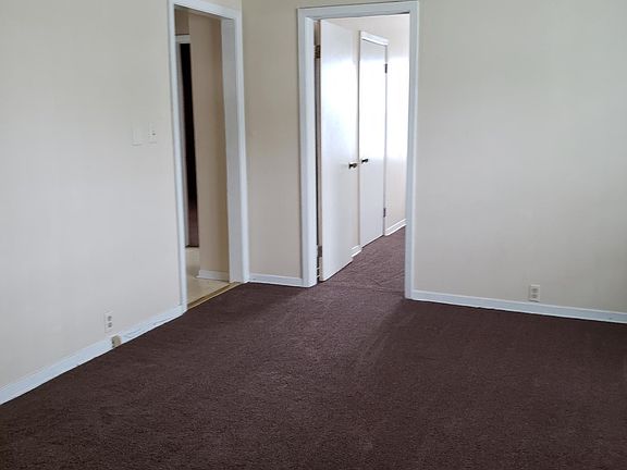 Living room looking at doorway to kitchen and 1 bdrm.