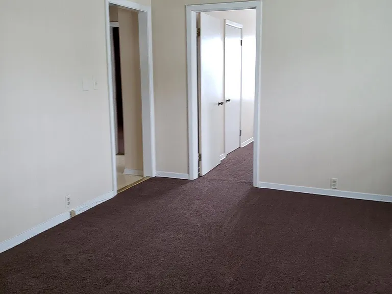 Living room looking at doorway to kitchen and 1 bdrm.