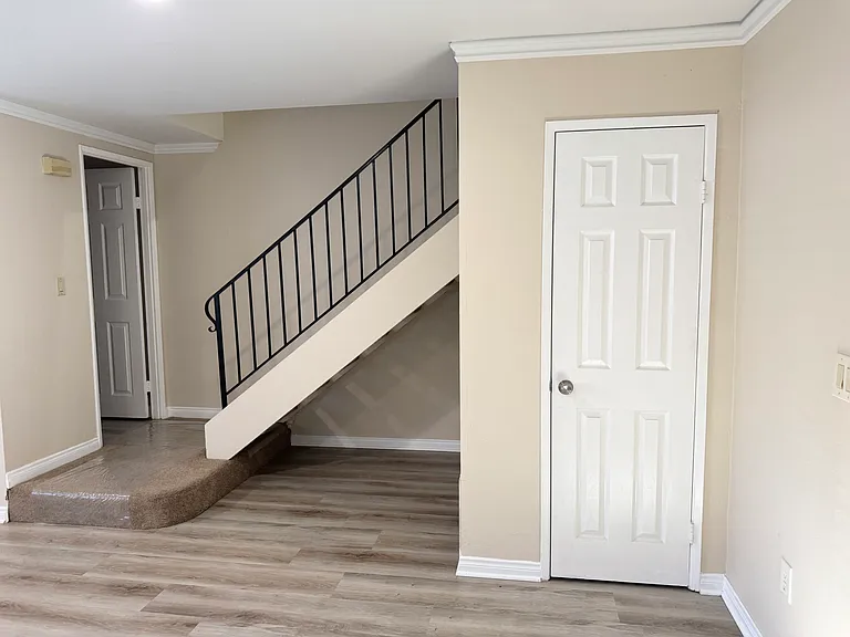 Staircase up. Large walk in storage under stairs.
