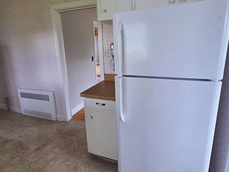 Functional kitchen with plenty of cabinets and a spacious refrigerator.