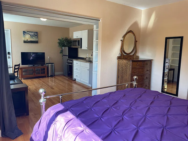 Bedroom also contains full antique dresser, mirror and large closet.