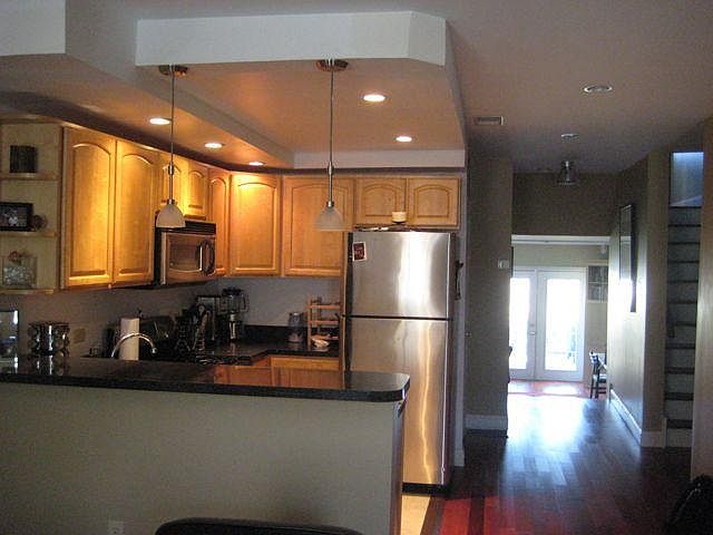 Kitchen and view to den and private deck.