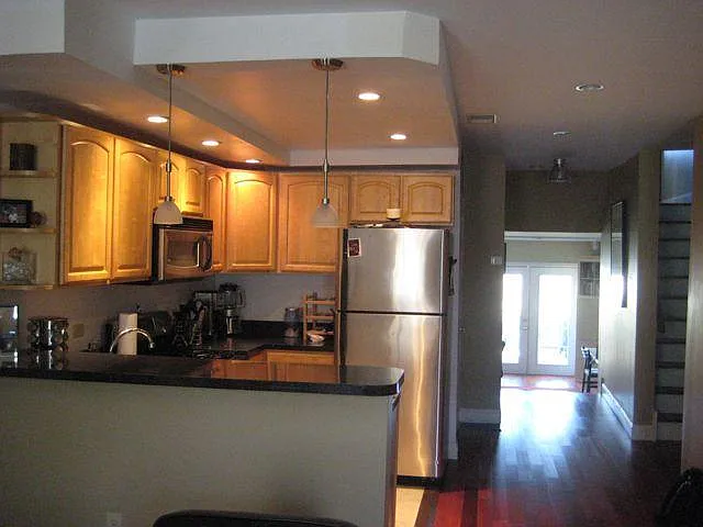 Kitchen and view to den and private deck.