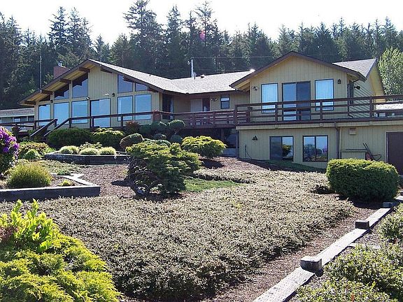 Back of home with large deck