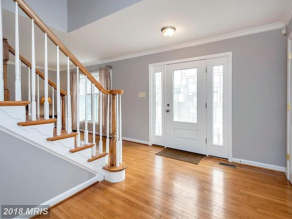 Foyer opens to living room and dining room