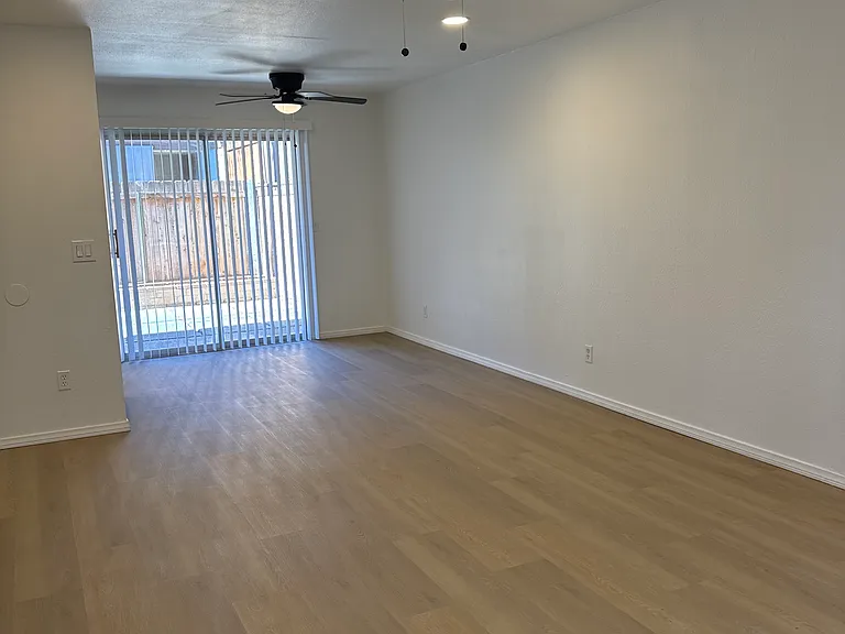 Living/dining area with sliding door to private paved patio containing closet with brand new washer dryer