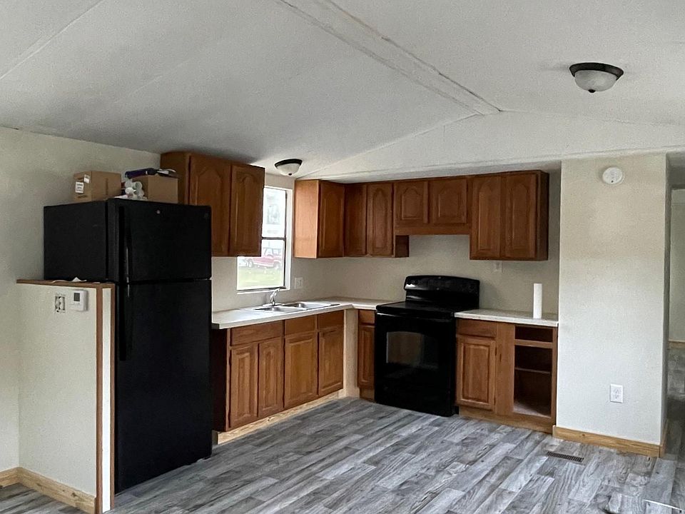 Kitchen with full cabinets and nice corian countertops.