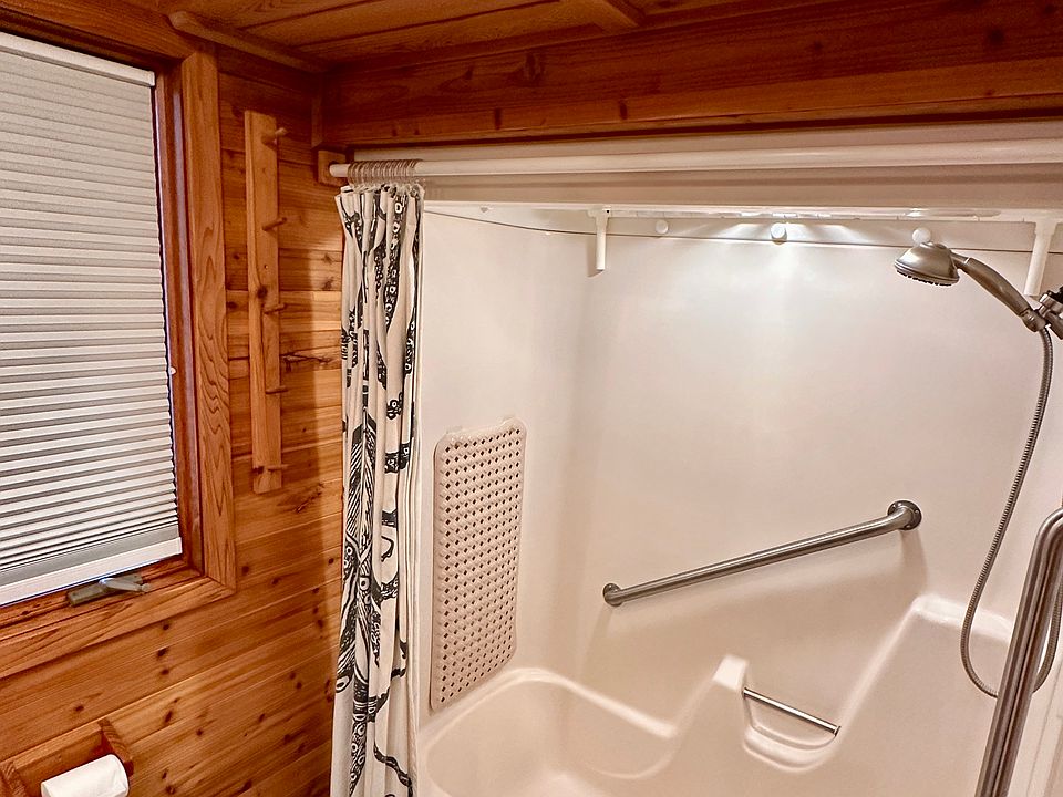 Cedar lined bathroom with slate tile floor.