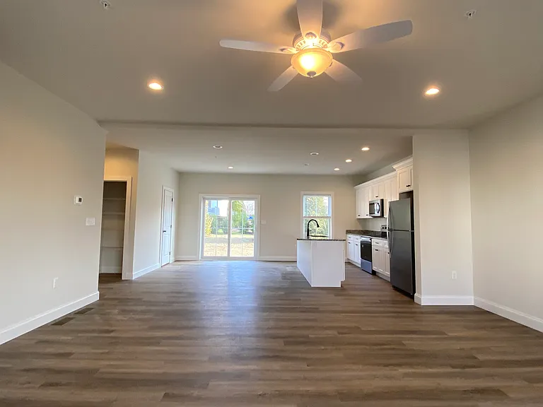 Open concept kitchen, living dining and walk out to patio
