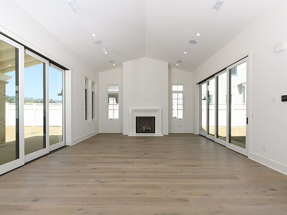 Great room with high ceilings, stacked sliding glass doors on both sides