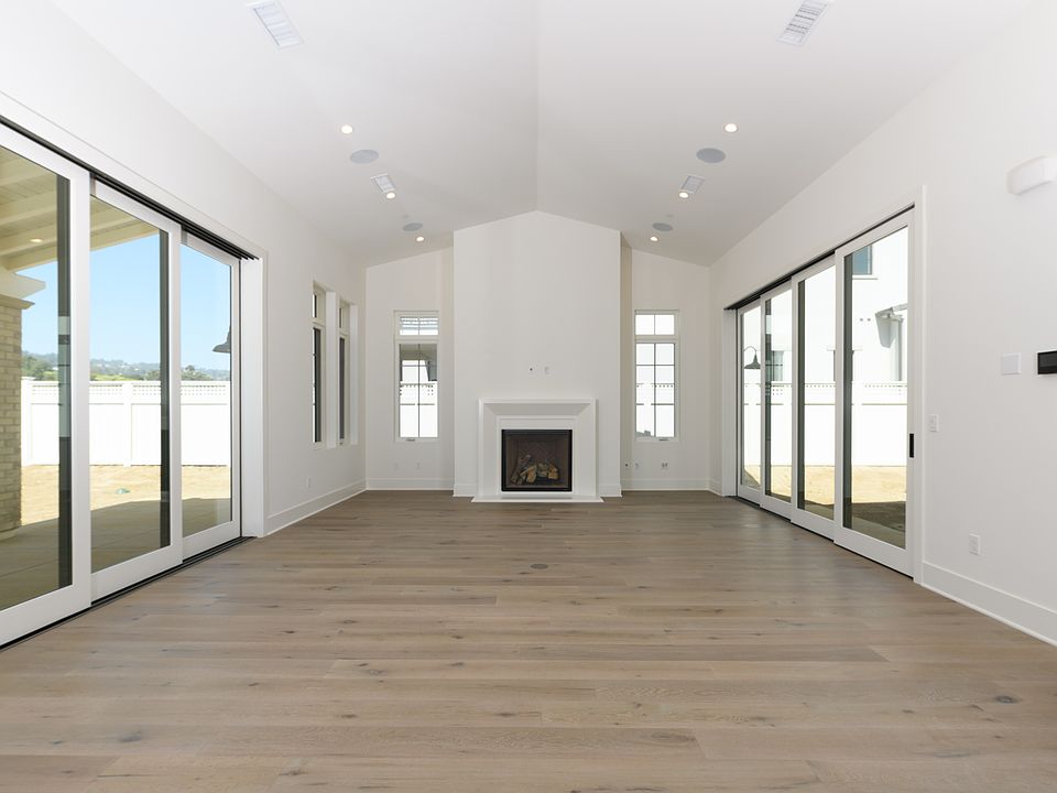 Great room with high ceilings, stacked sliding glass doors on both sides
