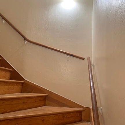 Stairs leading up to the living room, kitchen area, dining, and living spaces