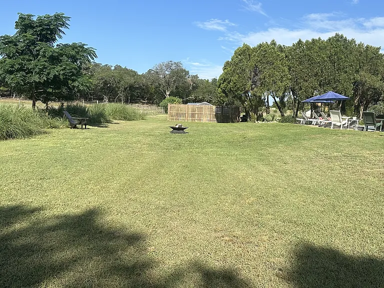 Behind the pool.