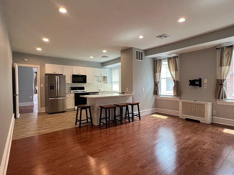 View from top of stairs, living room into kitchen