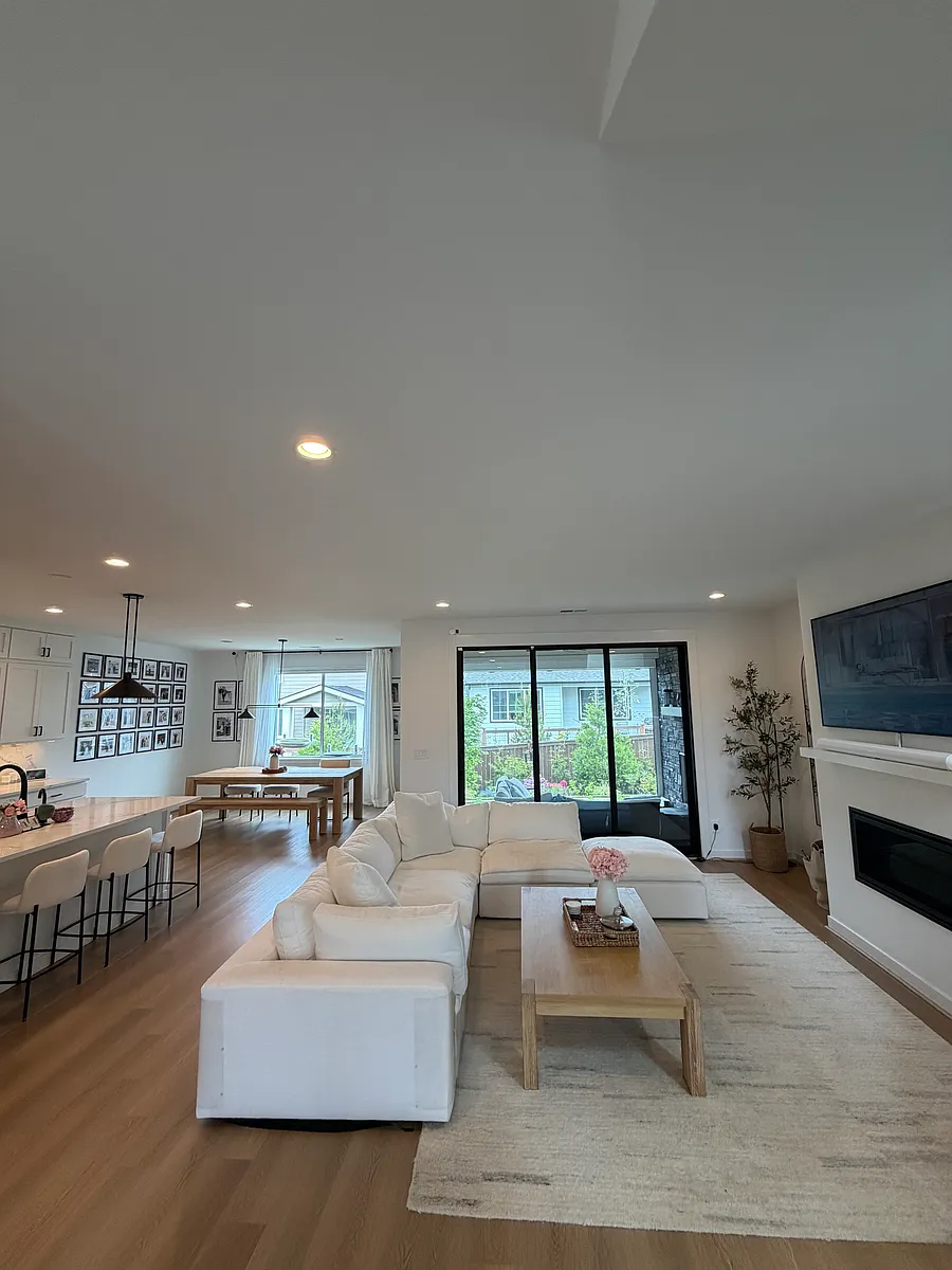 Open-concept main level with kitchen, dining, and great room flowing to the screened porch - 26816 NE 141st Pl
