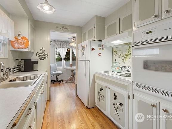 The kitchen features lots of cabinet and counter space, tile backsplash, new dishwasher and a walk-in pantry.>