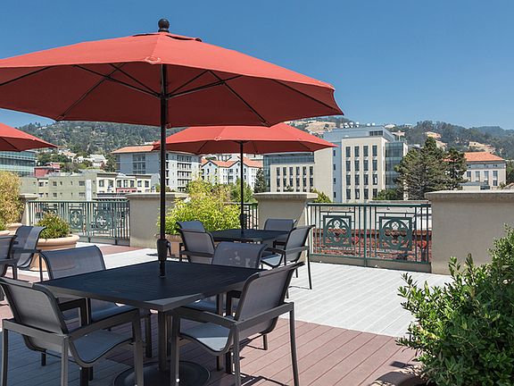 Outdoor seating on our rooftop deck with views of downtown and the Berkeley Hills
