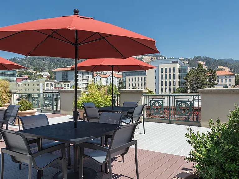 Outdoor seating on our rooftop deck with views of downtown and the Berkeley Hills