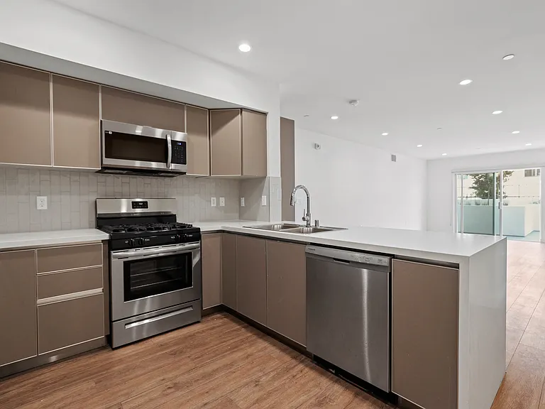 Open-Concept Kitchen with Energy-Efficient Appliances and Countertop Bar