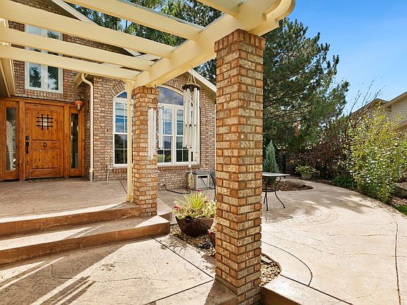 Front patio includes chairs and tables for taking in the expansive mountain and golf course views.