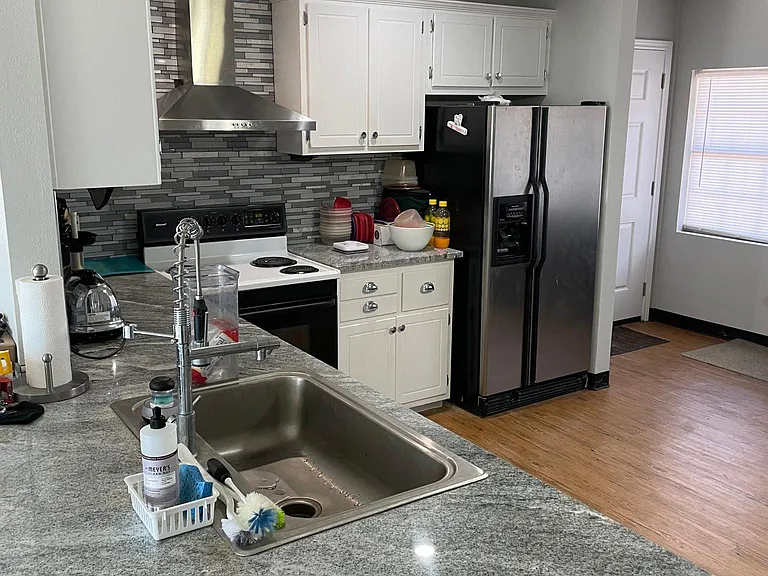 gray granite, cool light fixture and stove vent.