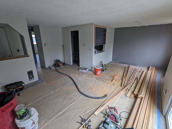 Main living area shown. New floors, trim work, sliding glass door, and fresh paint. Unit is currently under remodel.