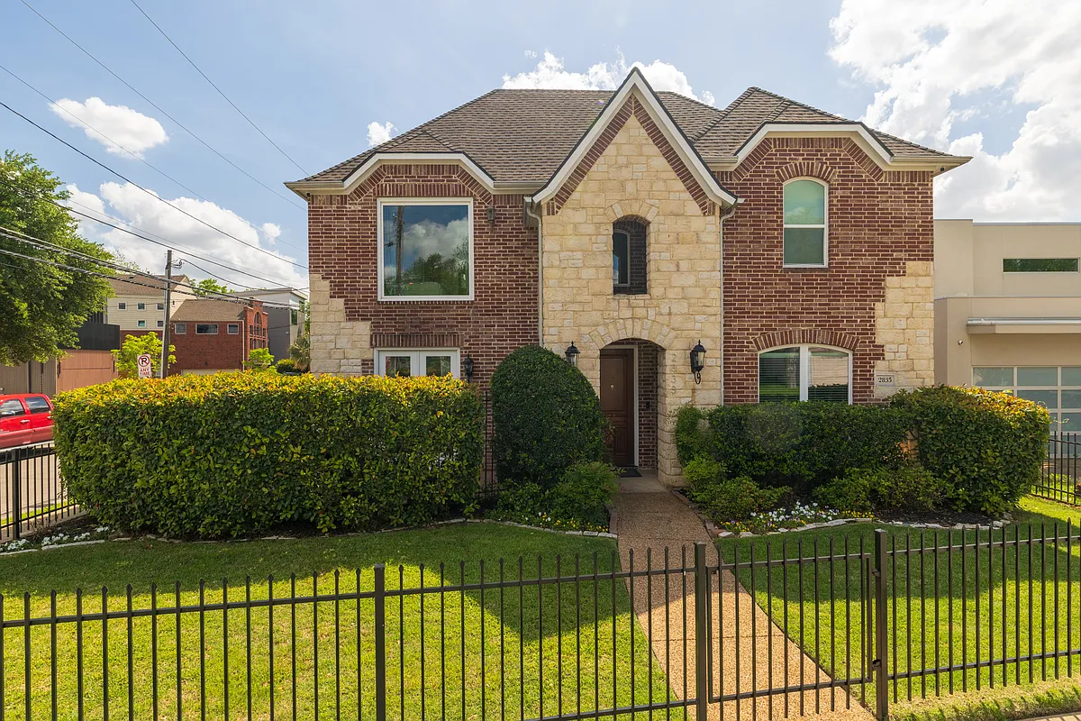 Beautiful brick and stone exterior with a gated front lawn - 2833 Lee St
