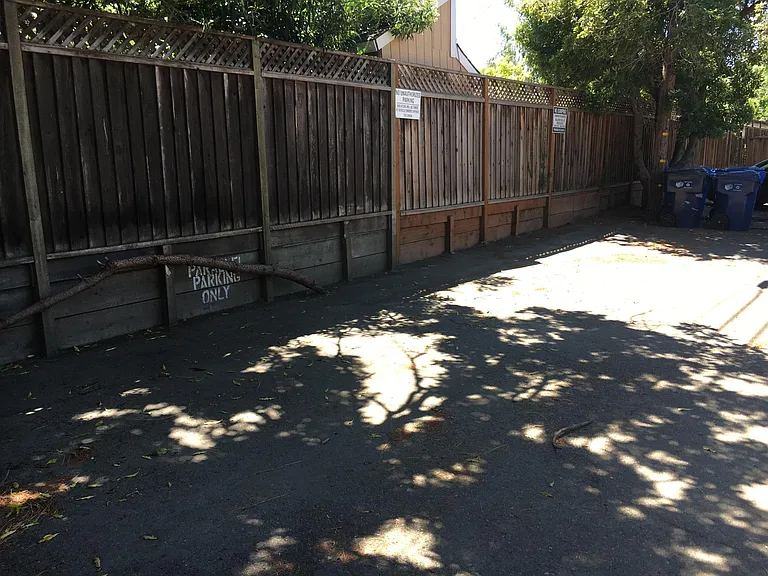 designated parking spaces along fence
