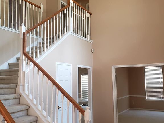 Stair case to upstairs, vaulted ceiling entrance with a majestic view